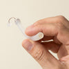 Back2Sleep nasal stent gently held between thumb and forefinger