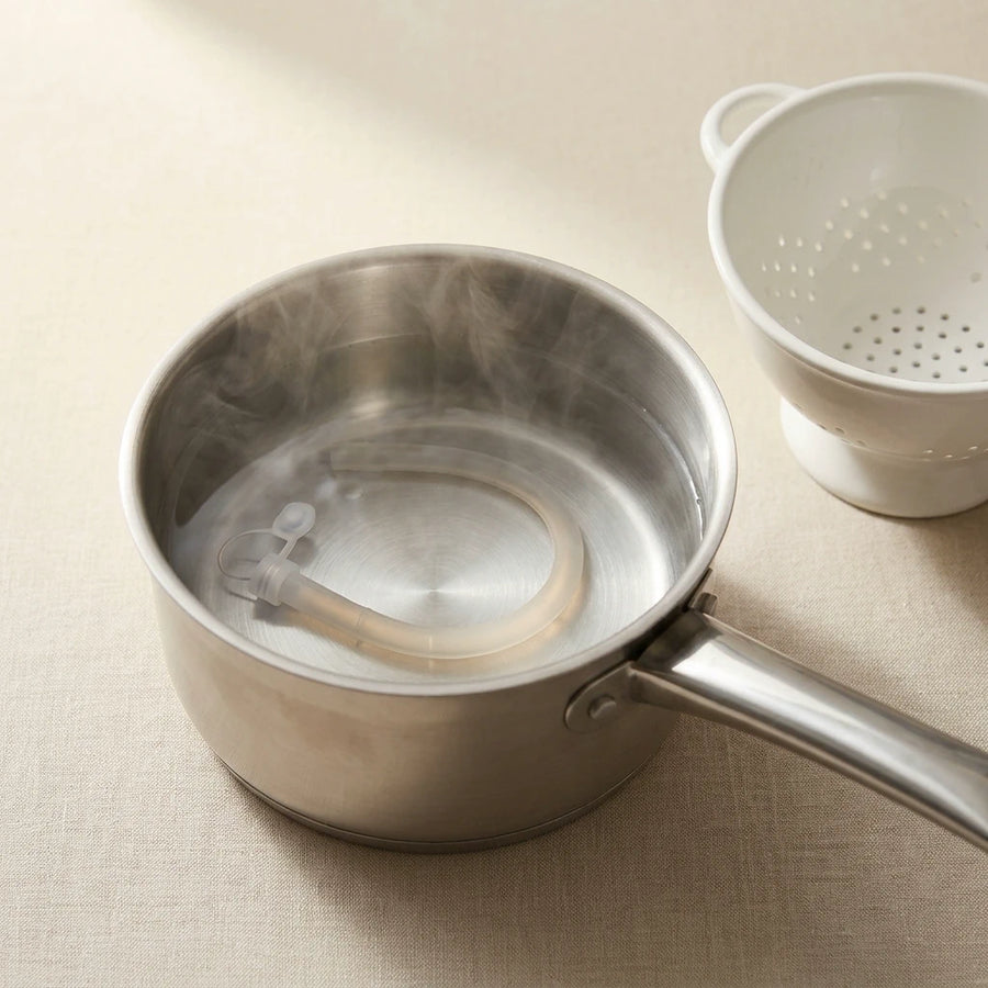 Back2Sleep silicone nasal stent fully submerged in boiling water in a saucepan to sterilize it