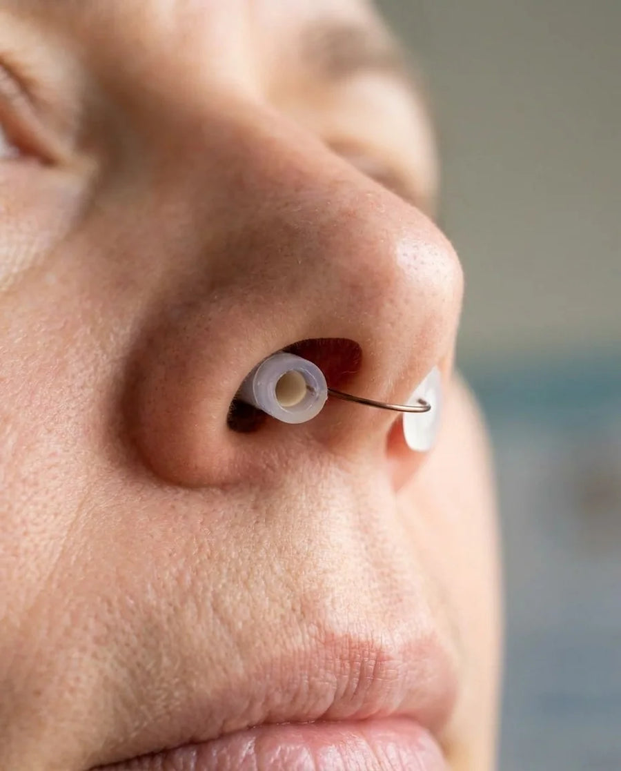 Inserting the Back2Sleep nasal stent into the nostril in front of a mirror